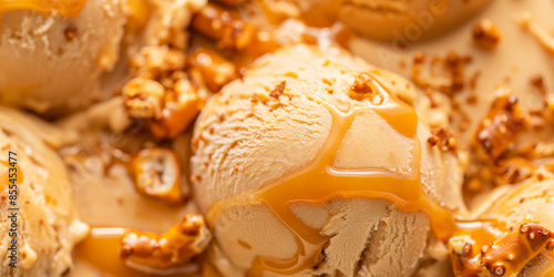 Decadent salted caramel and pretzel ice cream, a closeup of decadent salted caramel and pretzel ice cream, its rich color and bits of pretzel against a white background