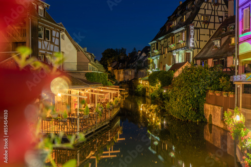 A colored night and reflection in Petite Venise of Colmar in France on 15th march 2024