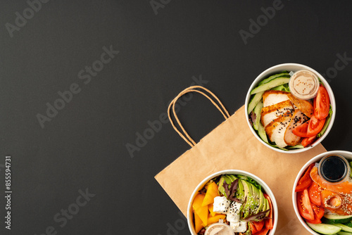 Side view of fresh poke bowls on black background