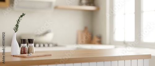 A minimal wooden kitchen island with a blurred background of a minimalist Scandinavian kitchen.