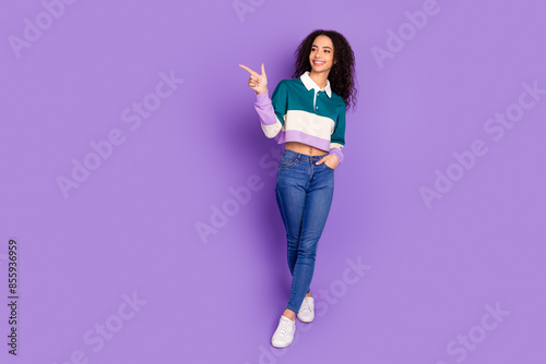 Full body portrait of lovely young girl direct finger empty space wear shirt isolated on purple color background