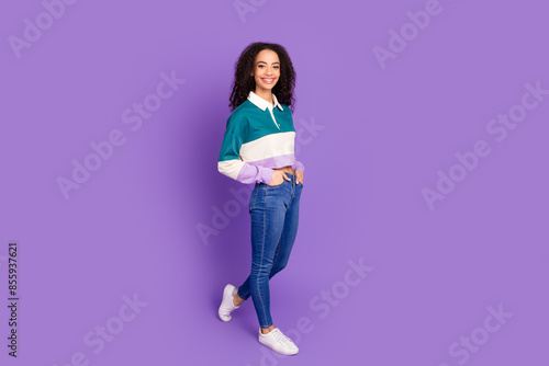 Full body portrait of lovely young girl walk empty space wear shirt isolated on purple color background