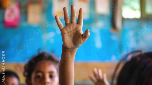 Close up of elementary student hands raised hand for answering question. AIG42.