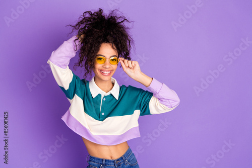 Portrait of lovely young girl touch hair empty space wear shirt isolated on purple color background