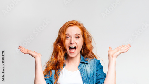 A red-haired woman is shown in the photograph, her eyebrows raised and mouth agape in a surprised expression.