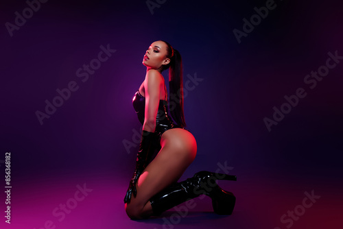 Profile side photo of african american girl feel passionate sit wear leather suit boots over neon background