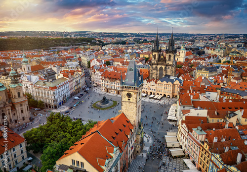 Elevated sunset view of the town square in the old city center of Prague, Czech Republic, with Tyn Church and Astronomical Clocktower