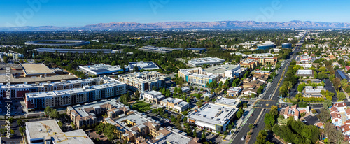 Aerial panoramic view of Main Street Cupertino residential and commercial neighborhood in San Francisco Bay Area, California. Silicon Valley skyline