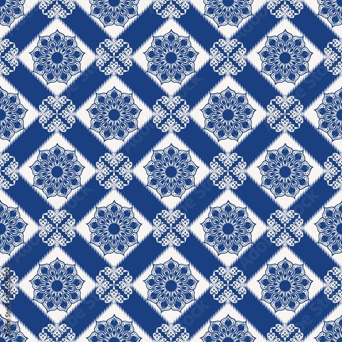 Blue color peranakan floral tile pattern. Illustration ikat mandala floral geometric shape seamless pattern. Ethnic geometric pattern use for fabric, textile, home decoration elements, upholstery, etc