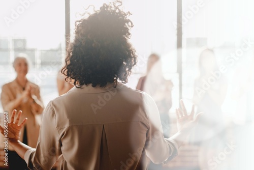 African american female empowering other colleagues in workplace