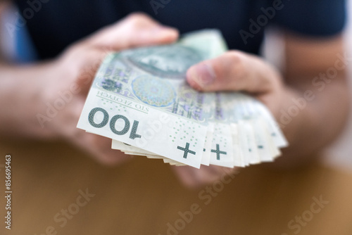 Osoba trzymając w dłoni banknoty. Biznes i finanse. 