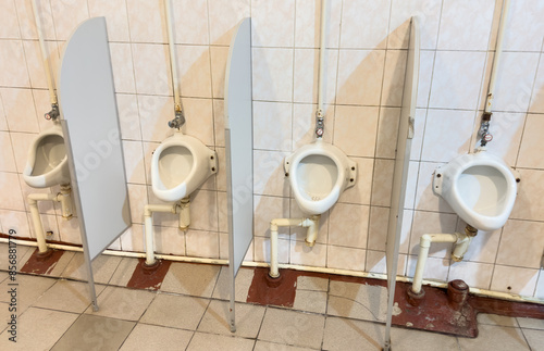 Public men's restroom. Urinal in men's restroom. Interior of bathroom with Toilet Urinal for man. Public toiletroom for mans. Soft focus