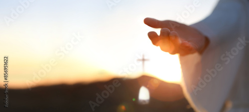 Hands of Jesus resurrected from the tomb and bright light background, heaven and cross love and salvation concept 