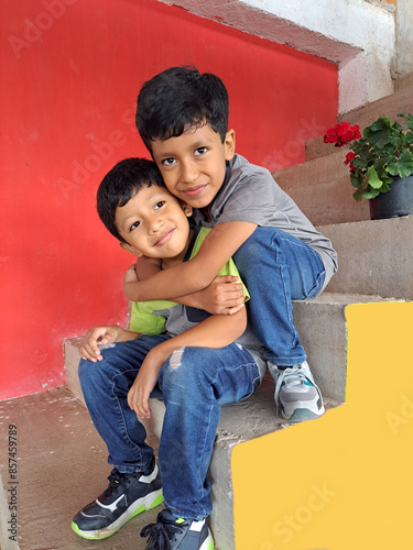 Two 7-year-old male children hug each other like brothers, showing their brotherhood in poverty