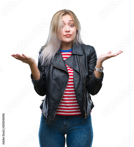 Young blonde woman wearing black jacket over isolated background clueless and confused expression with arms and hands raised. Doubt concept.