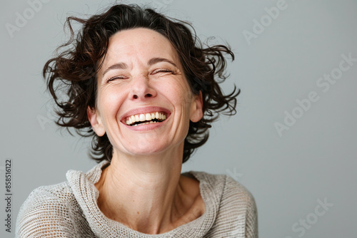 portrait of brunette woman hearty laughing
