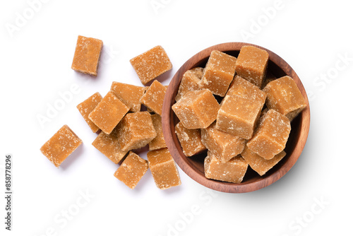 Brown cane sugar cubes in wooden bowl isolated on white background, top view, flat lay.