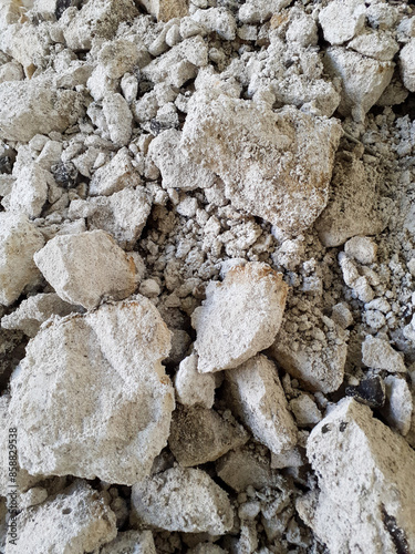 Close-up of RAAC concrete debris with various sized fragments. Reinforced autoclaved aerated concrete demolition waste.