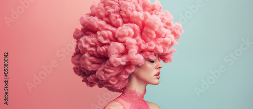 A surreal portrait of a woman with an extravagant pink cloud-like hairstyle set against a pastel pink and blue background.