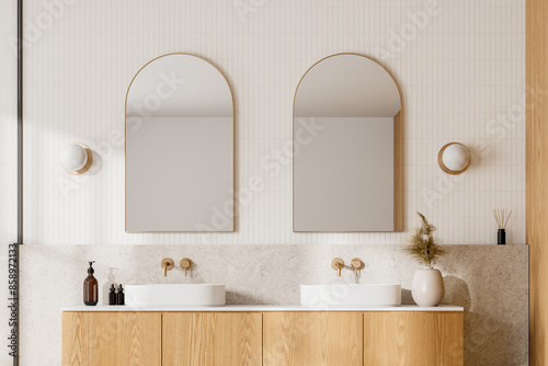 Modern bathroom with wooden cabinets, dual sinks, and arched mirrors, light background. Contemporary home or hotel concept. 3D Rendering