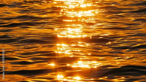 Golden sunset reflections on rippling water surface