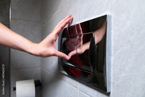 Economic toilet flush press with two separate buttons. Flushing water using dual machanism of concealed toilet cistern. Modern bathroom elements