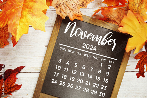 November 2024 monthly calendar maple leaf decoration on wooden background