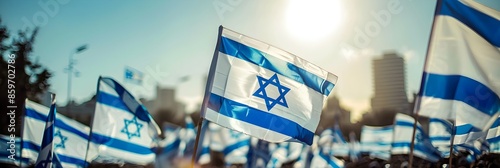 Multiple Israeli flags are held high in a crowd of attendees at a possibly national or political event