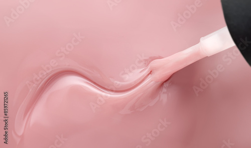 Pink nail polish and brush with wavy pattern