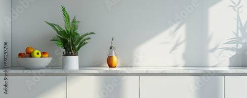 Minimalist kitchen podium background with clean lines, white surfaces, and simple, functional decor. A single plant and a bowl of fruit provide a touch of color in the otherwise neutral space.
