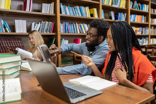 Young people studying in the library and looking involved