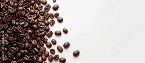 Coffee beans with copy space image on a white background, ideal for coffee-related concepts, like backgrounds or textures.