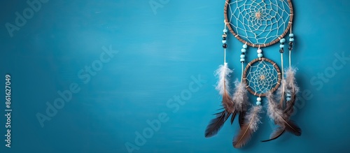 Top view of a dream catcher feature Asian attributes on a blue background with copy space image available.