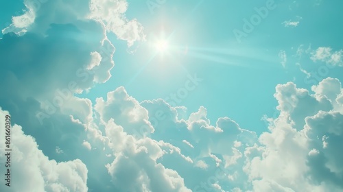 A bright beam of sunlight pierces through fluffy white clouds, illuminating a serene atmosphere