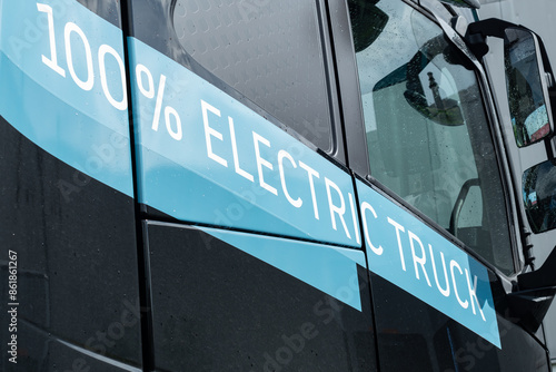 Blue sign on the side of a zero emission electric commercial haulage truck lorry stating that it is 100% Electric powered