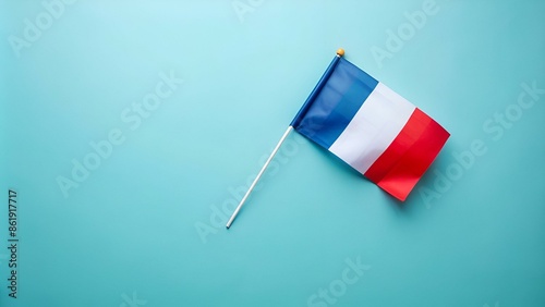 Celebration concept for France's Bastille Day holiday. Top view flat lay of french flag on pastel blue background with empty space for advert or message