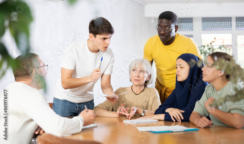 Men and women different ages discussion during business course