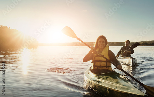 Couple, happy and lake outdoor for kayak or water sports in nature, paddling and rowing together for river journey. Man, woman and adventure date for bonding with love, fun and summer travel vacation