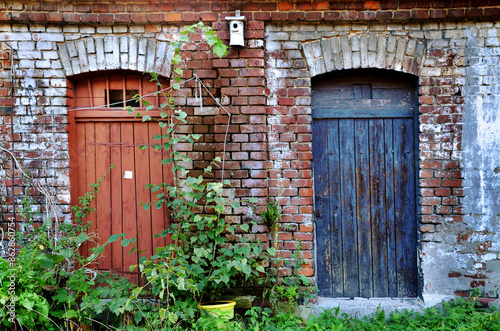 Brick building with two old doors of lumber rooms