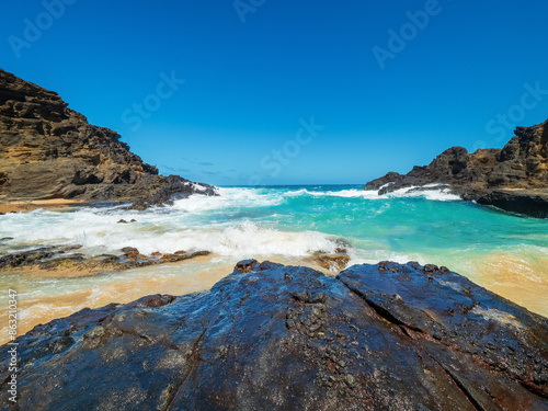 Halona Hawaii Beach Cove and the view to the lava coast with deep blue Pacific Ocean waves