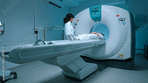 Patient in white clothes undergoes magnetic resonance imaging scan, laying down on bed for CT or PET scan, oncology machine scanning her body. Magnetic resonance diagnostics x-ray.