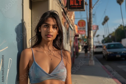 Young sexy woman standing on a city street