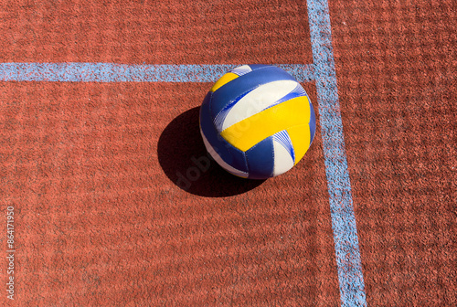 Volleyball ball on an outdoor court.
