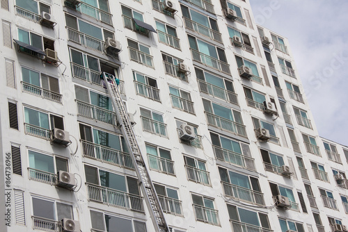  This is an apartment moving with a ladder truck.