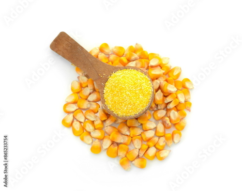 Uncooked cornmeal maize flour heap in a spoon and grains isolated on white background