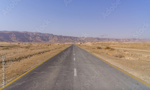 The scenic empty road going through Judean desert in the area of Masada national park in eastern Israel, on the border with Palestinian West Bank. 