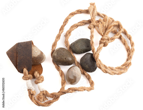 Antique Sling Shot and Stones on a White Background from the Story of David and Goliath in the Bible