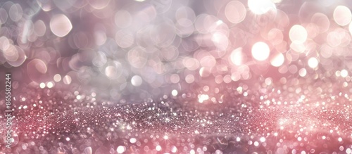 Glittery vintage lights backdrop in soft silver and pink hues, slightly blurred.