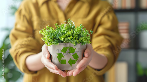 a person's hands holding a plant in a white vase, with a green leaf visible in the background