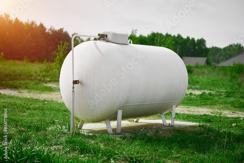 Rural home with large white propane gas tank